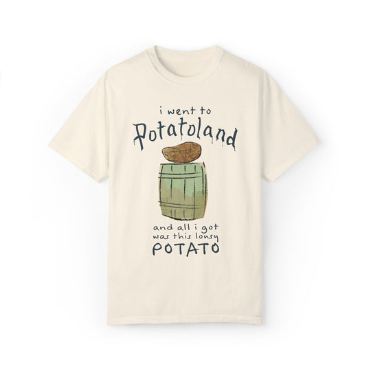 Potatoland Tee in Ivory, front flat lay with a potato on a barrel and the line and all I got was this lousy potato