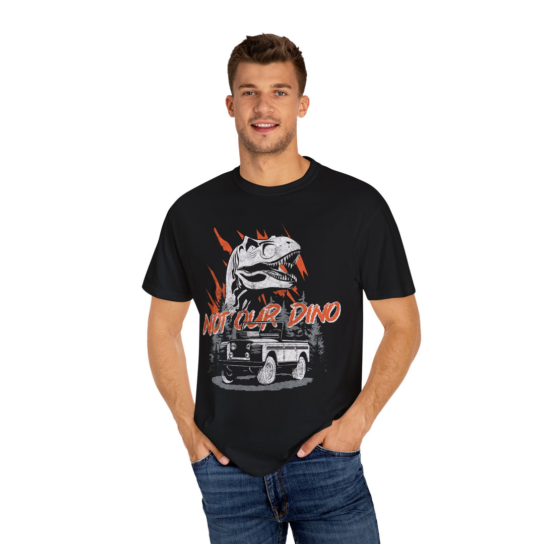 Not Our Dino Tee in Black worn by a man in jeans, front view of the Carnotaurus and jeep print