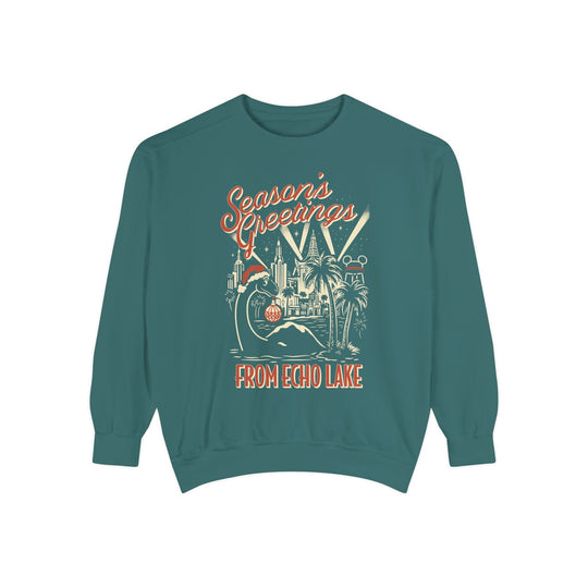 Seasons Greetings from Echo Lake Sweatshirt in Blue Spruce, front flat lay of Gertie the dinosaur in a Santa hat