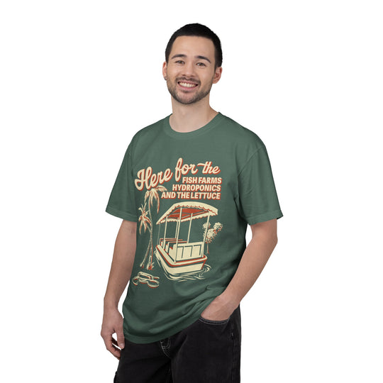 Living with the Land Hydroponics Tee in Blue Spruce worn by a smiling man, front view of the boat and palm design