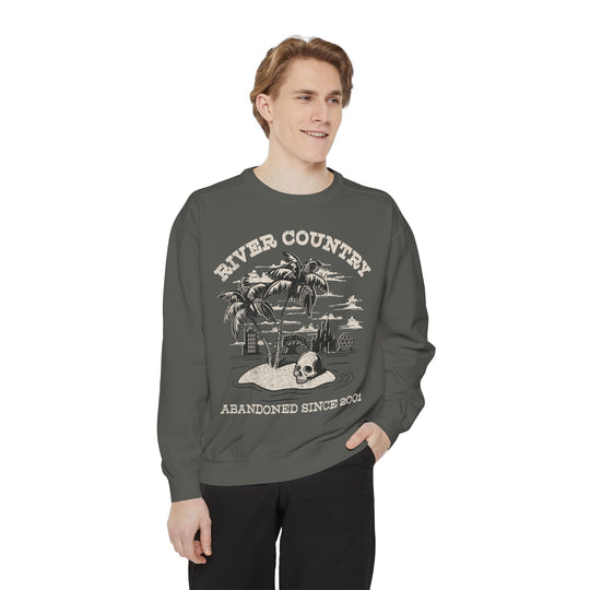 River Country Sweatshirt in Pepper worn by a smiling man, hand in pocket, front view of the River Country print