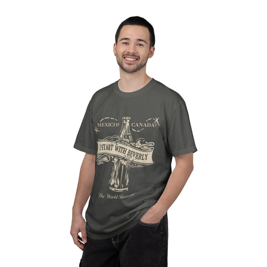 Drink Around The World Starting with Beverly T-Shirt in Pepper worn by a smiling man in black jeans, angled front view