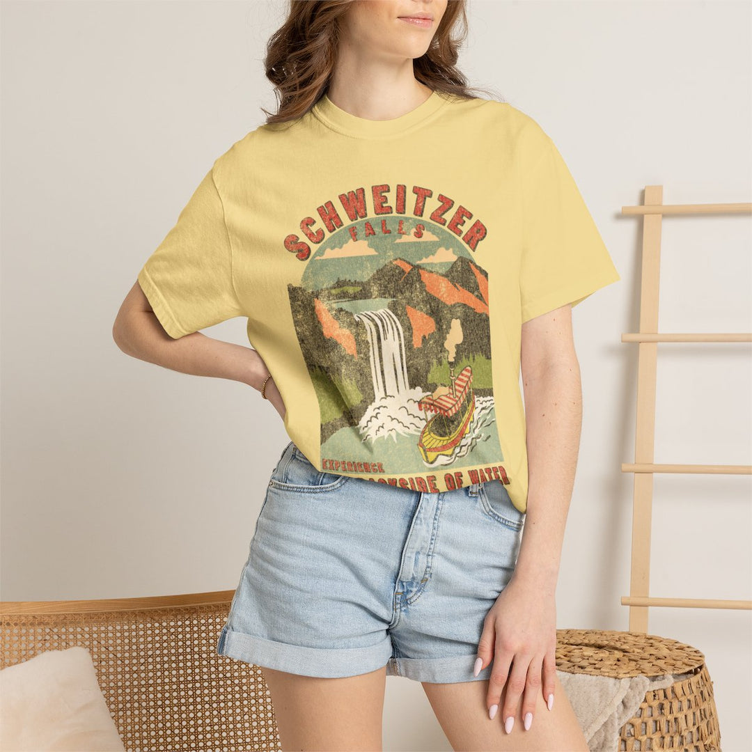 Schweitzer Falls Tee in Butter worn by a woman in denim shorts, tucked at the hip, waterfall print on the front