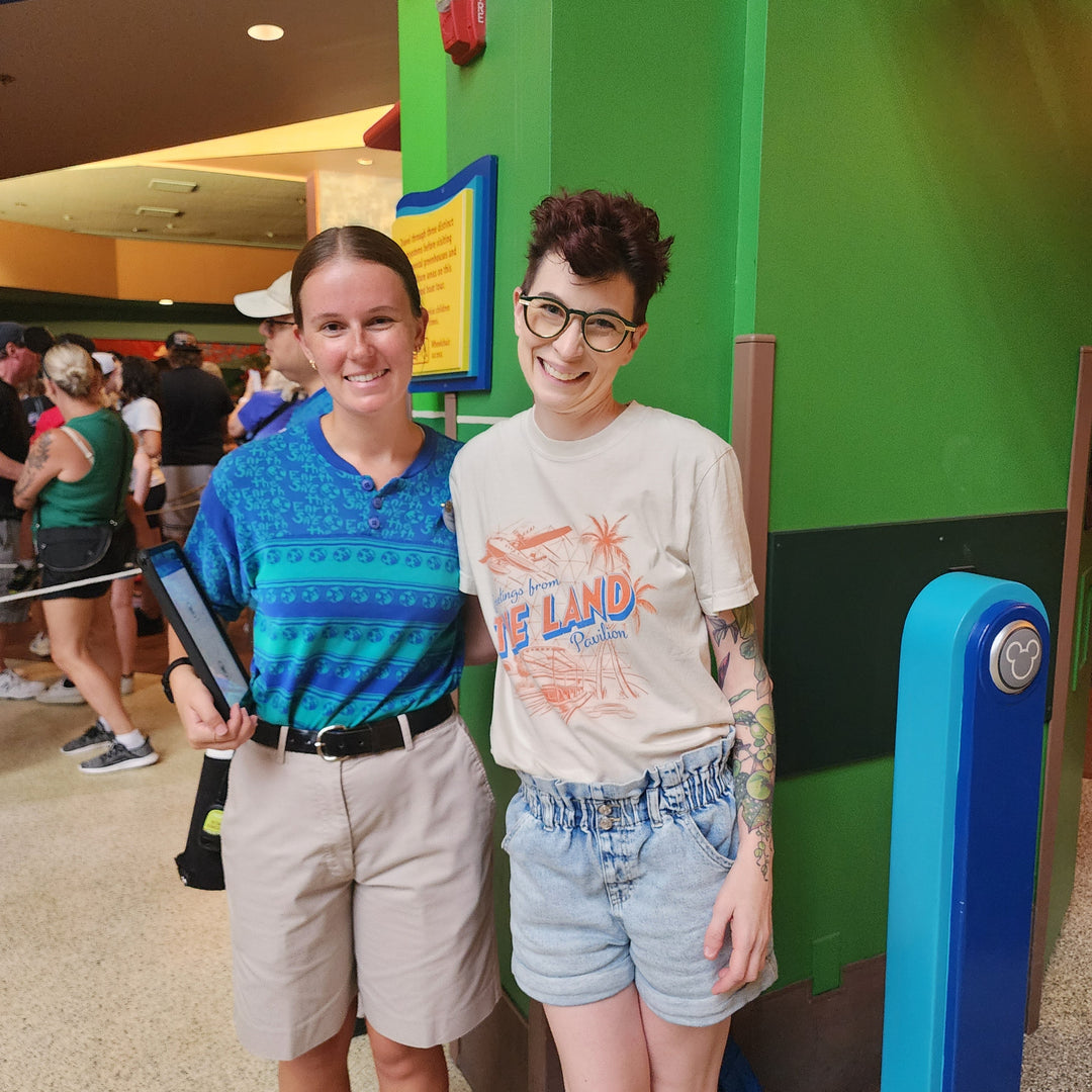 Kylie in the Land Pavilion Tee posing with a Living with the Land cast member inside the pavilion