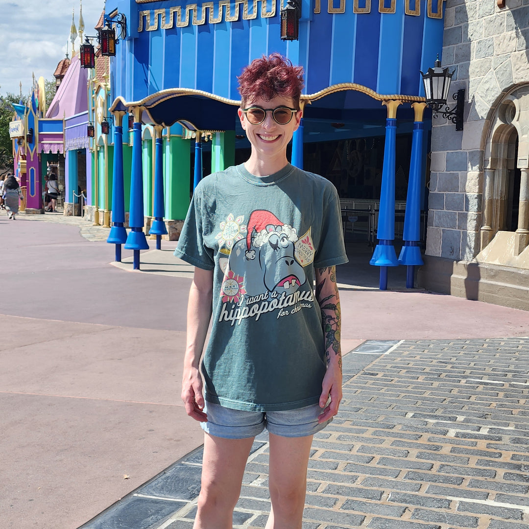 I Want a Hippopotamus for Christmas Shirt in Blue Spruce worn with denim shorts in Fantasyland