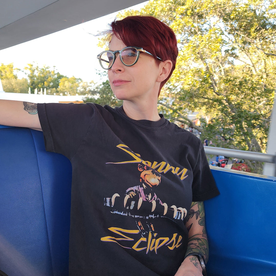 Kylie wearing the Sonny Eclipse Tee in Black while riding the Tomorrowland PeopleMover