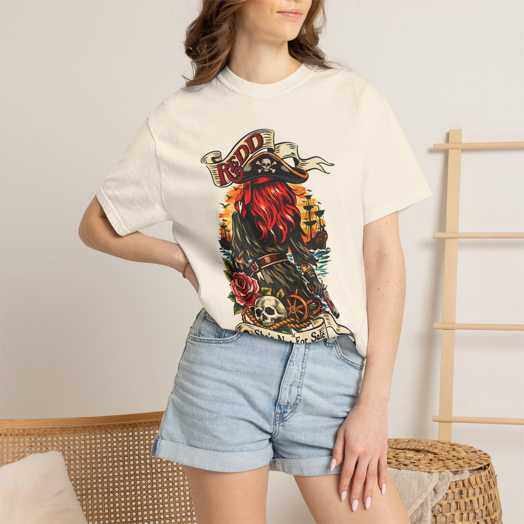 Redd Tee in Ivory worn by a woman in denim shorts, hand on hip, front view of the Redd pirate print