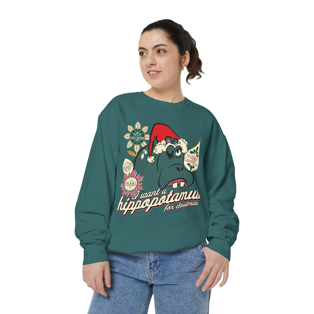 Christmas Hippo Sweatshirt in Blue Spruce worn by a woman in jeans, three-quarter view of the holiday hippo print