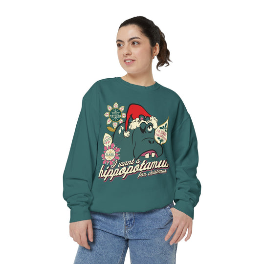 Christmas Hippo Sweatshirt in Blue Spruce worn by a woman in jeans, three-quarter view of the holiday hippo print