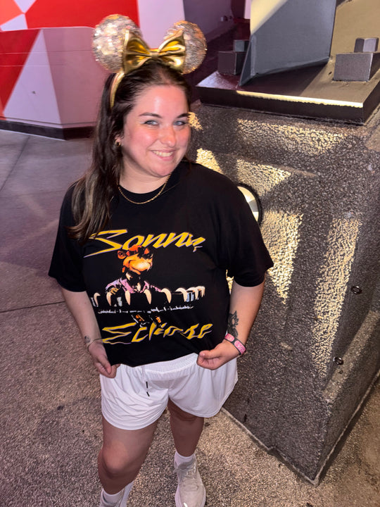 Sonny Eclipse Tee worn by a woman in sparkly Minnie ears and white shorts, standing in Tomorrowland