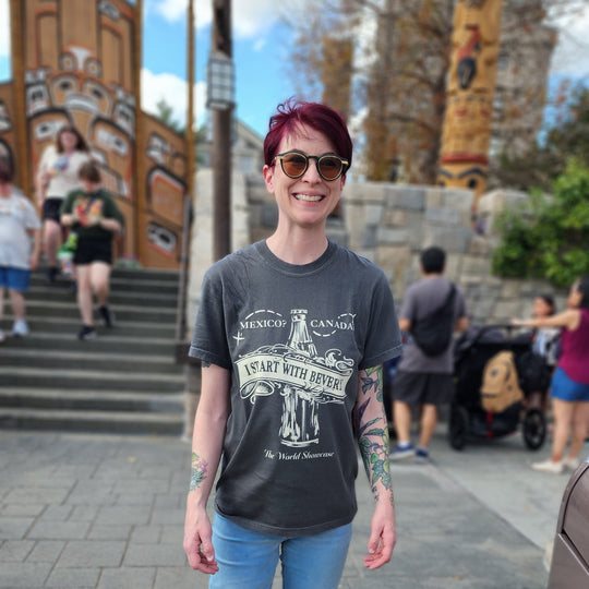 Kylie wearing the Starting with Beverly T-Shirt in Pepper in front of the totem poles at the Canada pavilion in Epcot