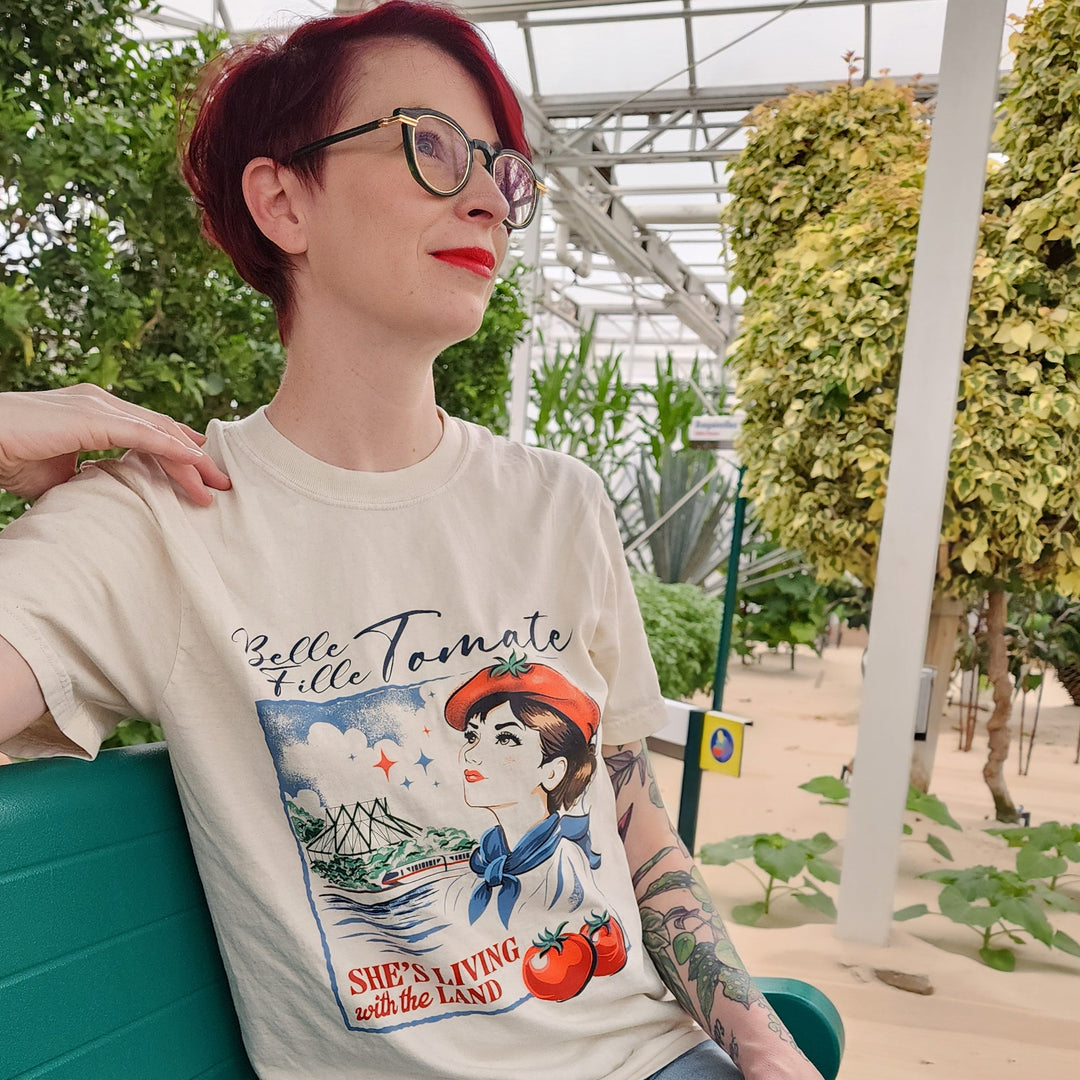 Kylie wearing the Tomato Girl Tee in Ivory on the Living with the Land boat in The Land greenhouses